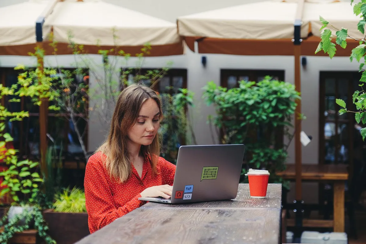 Malaysian entrepreneur working on a laptop at a coffee shop starting an online business