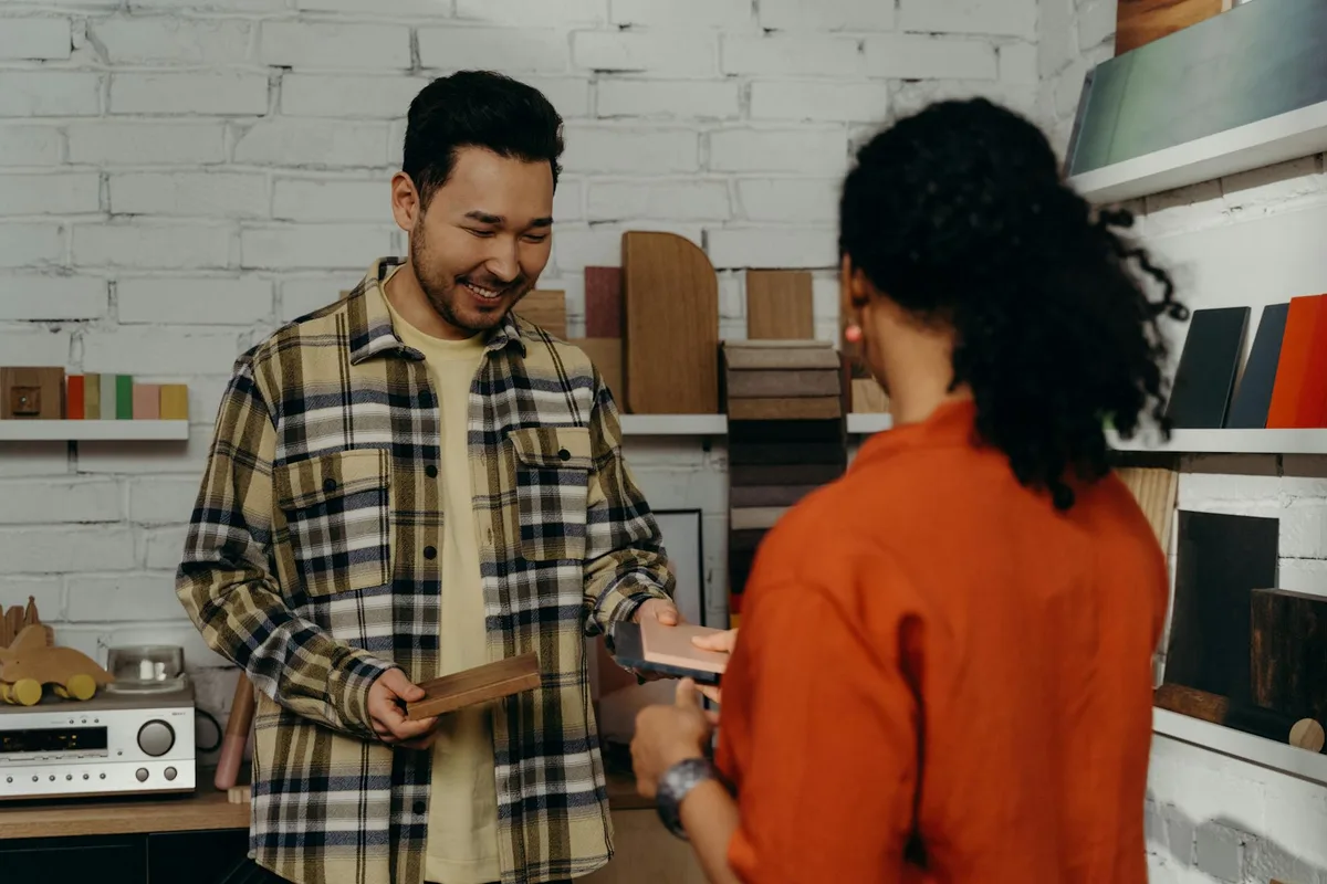 Malaysian seller reviewing print on demand product samples next to a laptop showing their Shopee store
