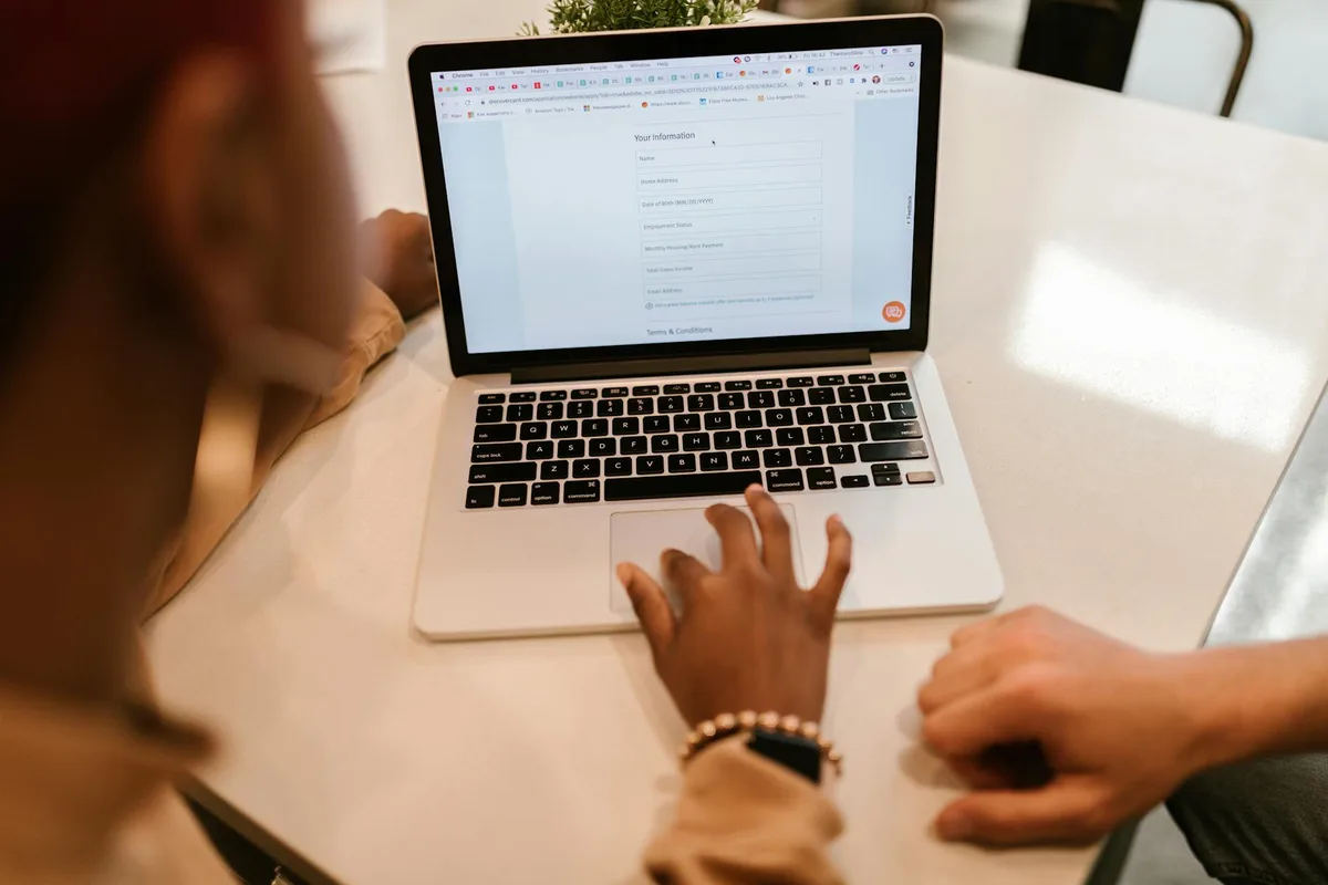 Malaysian entrepreneur completing SSM business registration on a laptop at a desk