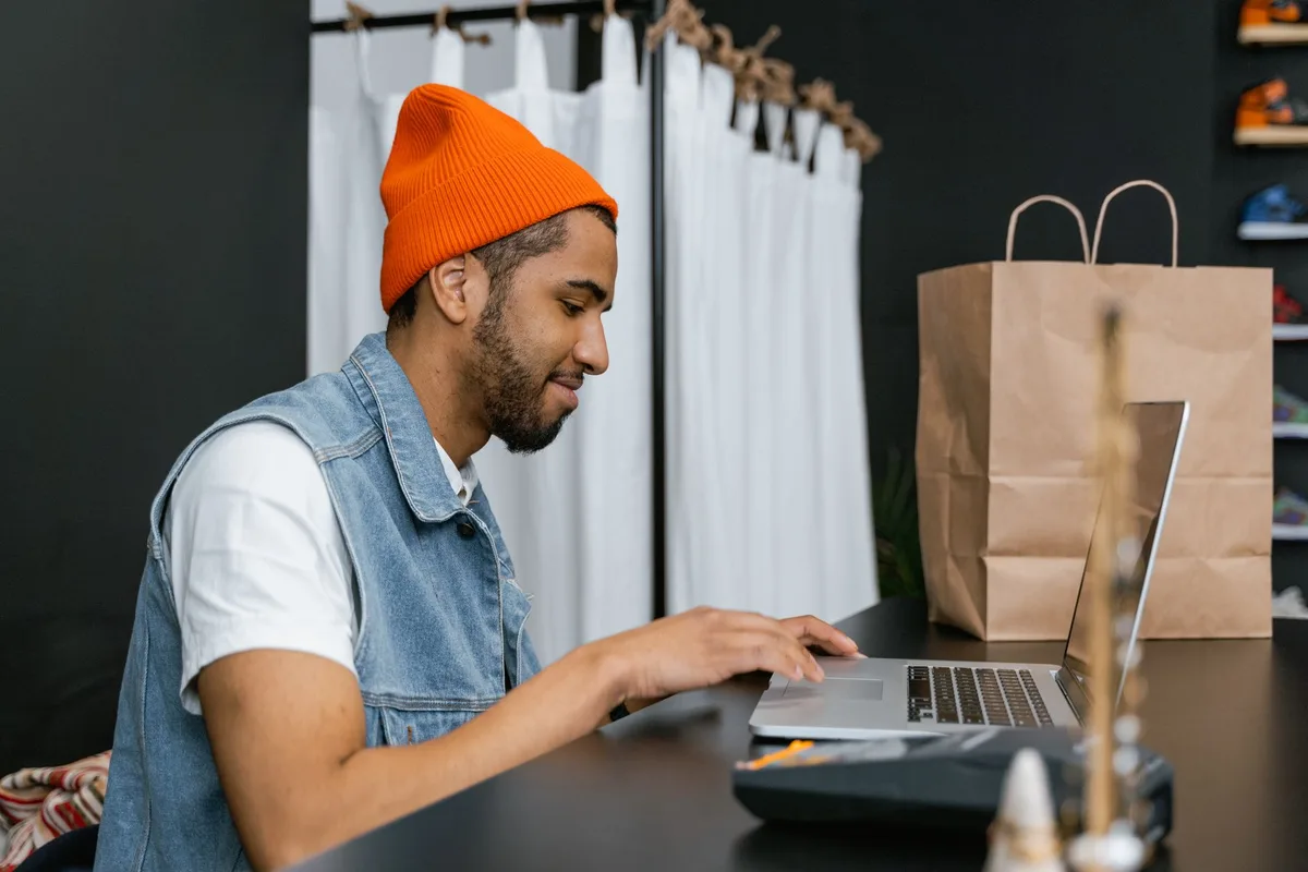 Filipino online seller comparing ecommerce platforms on a laptop