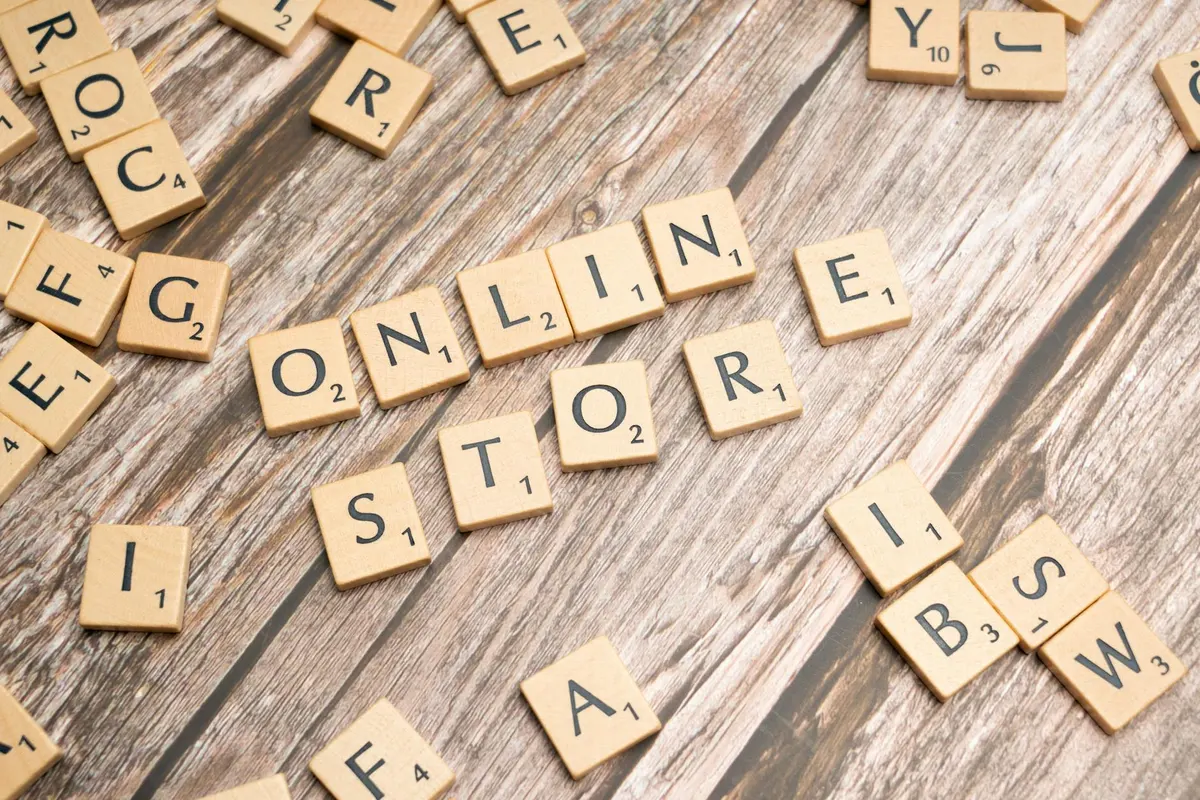 Malaysian seller comparing EasyStore and Shopify platforms on a laptop at a home workspace