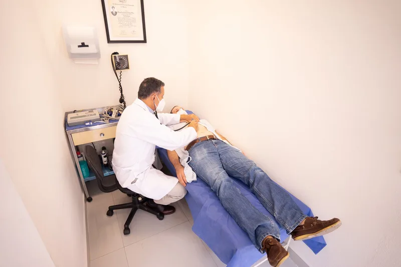 Medical professional performing a checkup in a clinic examination room