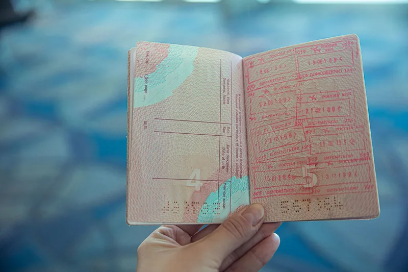 Open passport showing travel stamps, representing the final visa stamping step