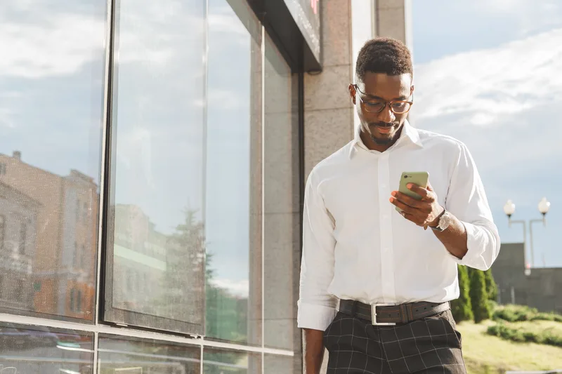 Person checking a smartphone while shopping online