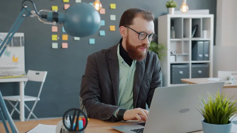 Entrepreneur working on a laptop while setting up a new online store