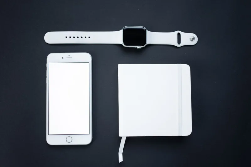 Smartphone and notepad used to plan an online store product listing