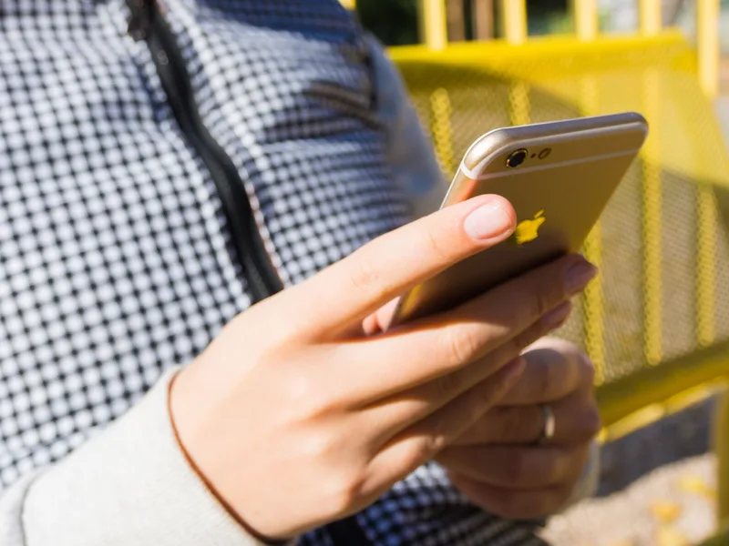 Filipino seller checking a new order notification for her Lazada Philippines shop on her smartphone