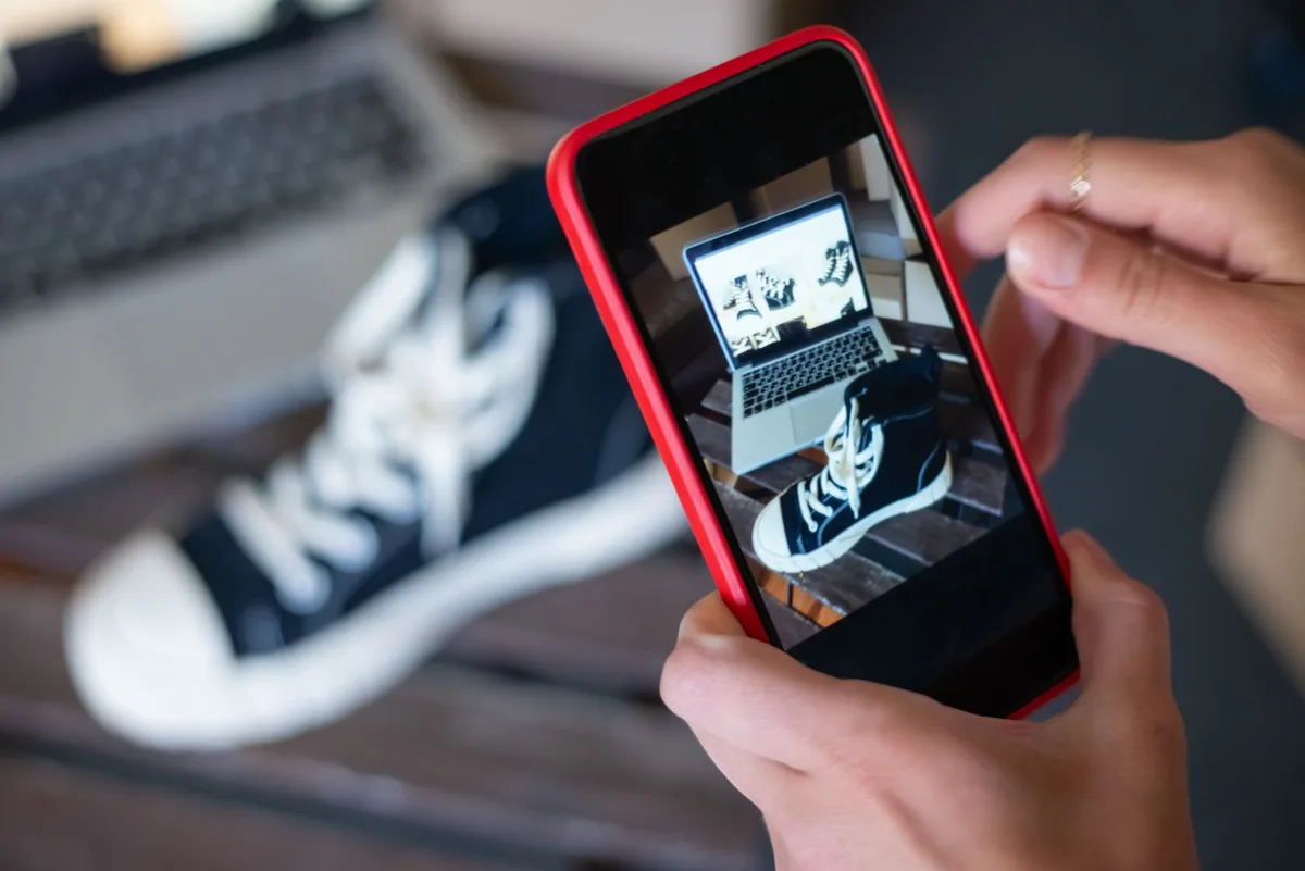 Seller in Malaysia filming a product on a smartphone to sell on TikTok Shop