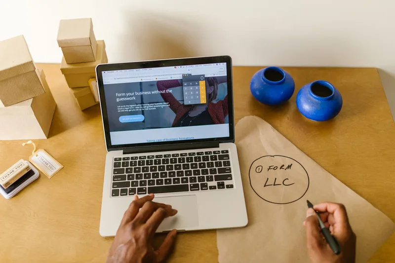 Workspace with laptop and packaging materials for a new online store