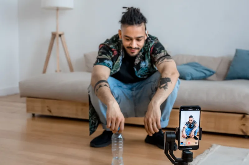 Person filming product content with a smartphone on a tripod