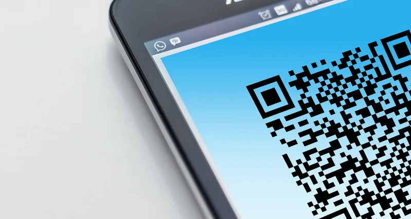 Smartphone displaying a QR code for a mobile payment scan